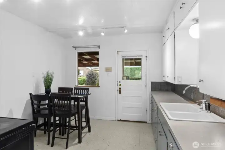 Kitchen with eat-in space and access to backyard.