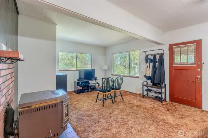 When you step inside, it feels a bit like a time capsule. The carpet that Grandpa chose all those years ago is still in good condition, holding onto the history of the home. The pellet stove stands ready as a focal point in the room, though it hasn’t been used in years and may need some attention before it comes back to life.