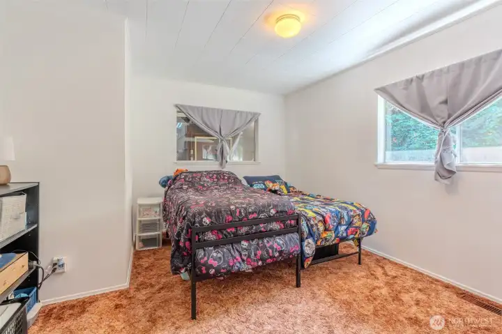 The first bedroom offers a comfortable amount of space, easily accommodating a king-size bed if you choose. With natural light from the window and a simple layout, it’s a flexible room that can adapt to your needs.