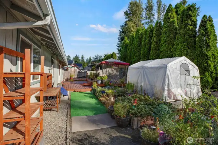 Look at this mini homestead! Greenhouse stays