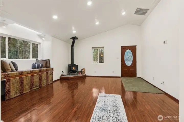 As you enter, you will find GORGEOUS laminate flooring, soaring ceilings along with amazing wood stove and delightful bench seat in your family room.