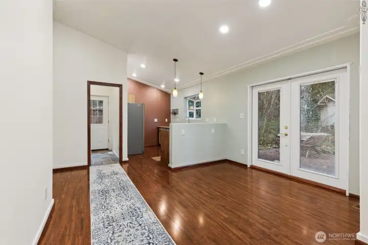 View from entry to dining area and kitchen, open concept makes it feel so roomy and HUGE French patio doors leading to your deck. Straight ahead on your left is your utility room with back entrance.