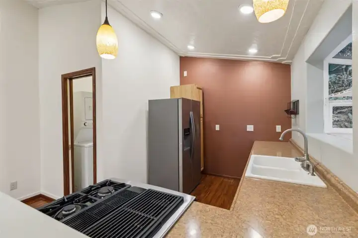 Kitchen view one, included newer propane stove and refrigerator.