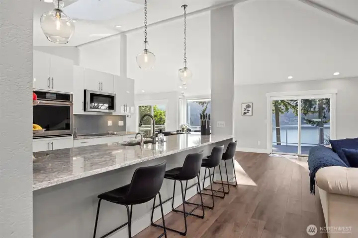 Opening up to a spacious west facing deck with panoramic lake views.