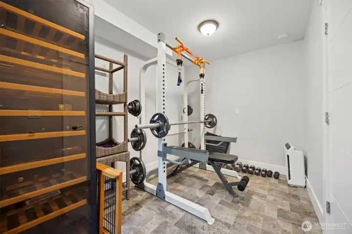 Flex area for gym equipment or wine storage. Or use as the private entrance to the lower living space w/ kitchen, bed and bath.