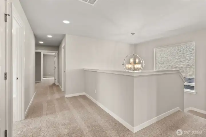 Second floor landing and expansive hallway between bedrooms.