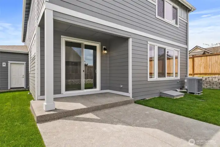 Backyard features a service door from garage and a great patio to hang out on.