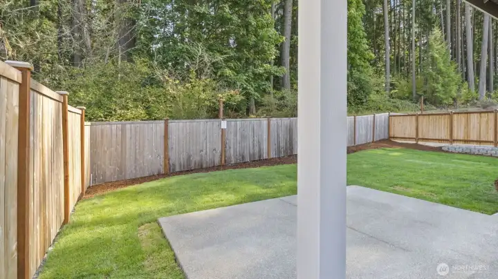 Similar, not actual. Back-yards professionally landscaped & fully fenced with 6’ cedar privacy fencing. This home features a serene, natural backdrop.