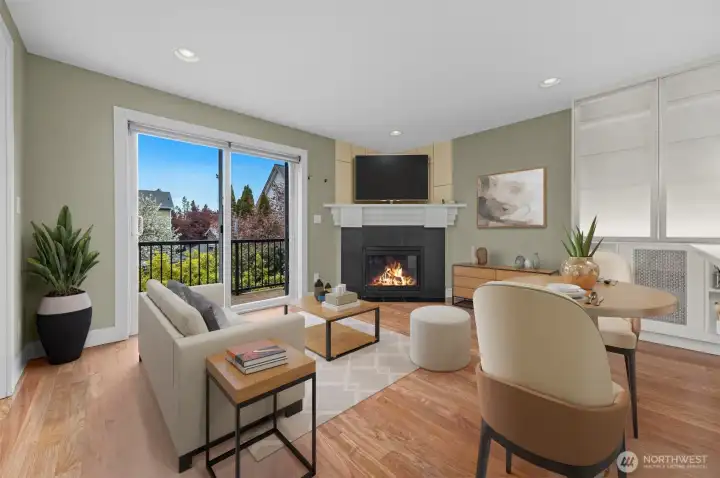 Virtual Staging  A warm and inviting living room features a cozy fireplace and flows seamlessly into the open kitchen, creating the perfect space for both everyday living and entertaining. The open-concept design enhances connection and natural light throughout the main level.