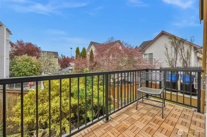 A private deck, located just off the living room, overlooks the spacious back patio below, offering an elevated outdoor retreat perfect for morning coffee or evening relaxation. This thoughtful outdoor layout creates seamless indoor-outdoor living with multiple spaces to gather, unwind, and enjoy the surroundings.