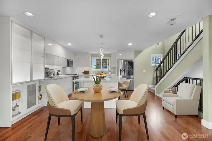 Virtual Staging  A bright, open view from the living room into the kitchen highlights the seamless flow of the main level, creating an airy and connected living space. The open-concept design enhances natural light and makes the home ideal for both everyday living and entertaining.
