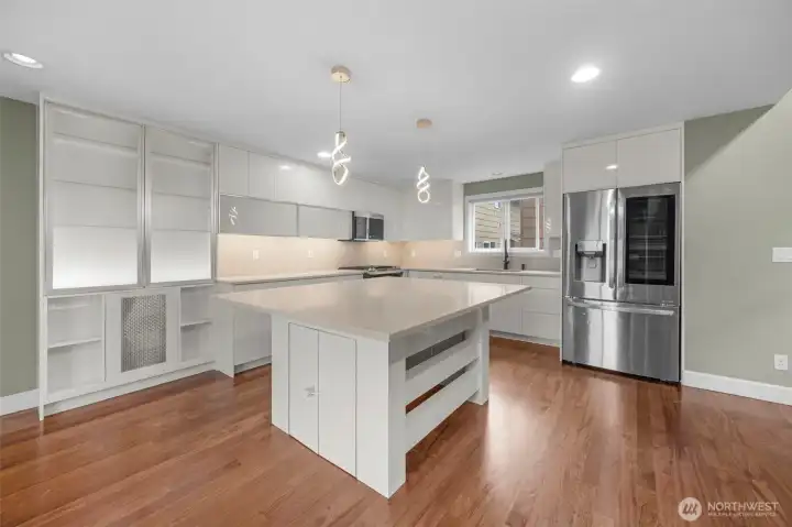 A gourmet chef’s kitchen showcases stylish modern custom cabinetry paired with sleek stainless steel appliances, creating a refined and highly functional space. Thoughtfully designed with both beauty and efficiency in mind, it’s perfect for cooking, entertaining, and everyday living.
