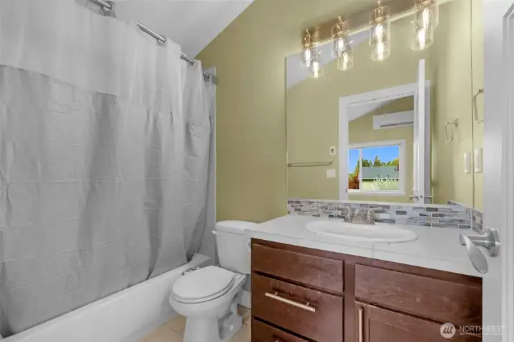 The ensuite bath is a stylish three-piece retreat, featuring modern new lighting fixtures that elevate the space with a fresh, contemporary feel. Clean finishes and thoughtful design create a bright and comfortable private bathroom experience.