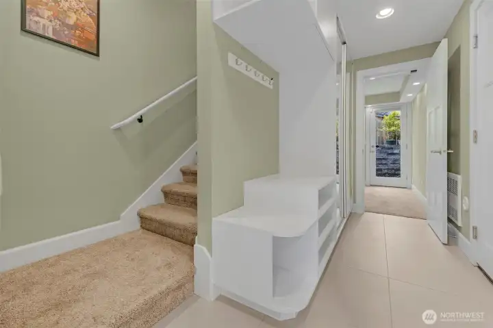 A functional and inviting entryway welcomes you home with built-in closet storage for everyday organization and convenience. From here, enjoy seamless access to the attached garage, creating an effortless transition between coming and going. Just off the entry, a well-appointed bedroom offers flexible space for guests, a home office, or additional living needs, all within a clean and efficient layout.