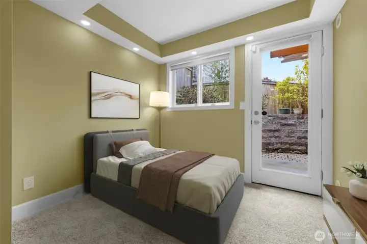 Virtual Staging  A private bottom-level bedroom offers comfort and flexibility, featuring brand new carpet and direct access to a secluded patio for seamless indoor-outdoor living. This versatile space is perfect for guests, a home office, or a quiet retreat, with a thoughtful layout that enhances both privacy and functionality.