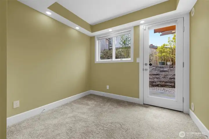 A private bottom-level bedroom offers comfort and flexibility, featuring brand new carpet and direct access to a secluded patio for seamless indoor-outdoor living. This versatile space is perfect for guests, a home office, or a quiet retreat, with a thoughtful layout that enhances both privacy and functionality.