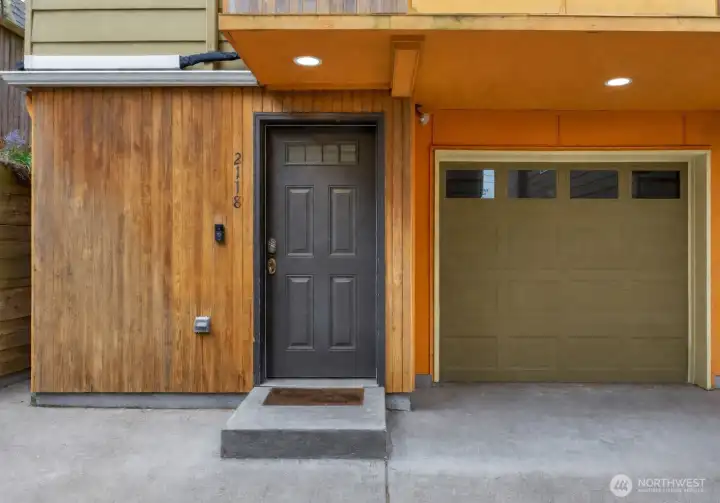 A welcoming front entry features a modern security camera for added peace of mind, combining style with enhanced safety. The thoughtfully placed system offers convenience and confidence while maintaining a clean, contemporary exterior aesthetic.