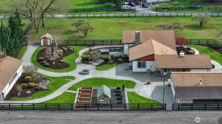 These grounds are "tight and right" this low maintenance set up with curbing and a blue tooth operated  sprinkler system, makes yard care a breeze!  Also, nestled up to the home you will find two Bosch variable speed Heat Pumps installed in 2024