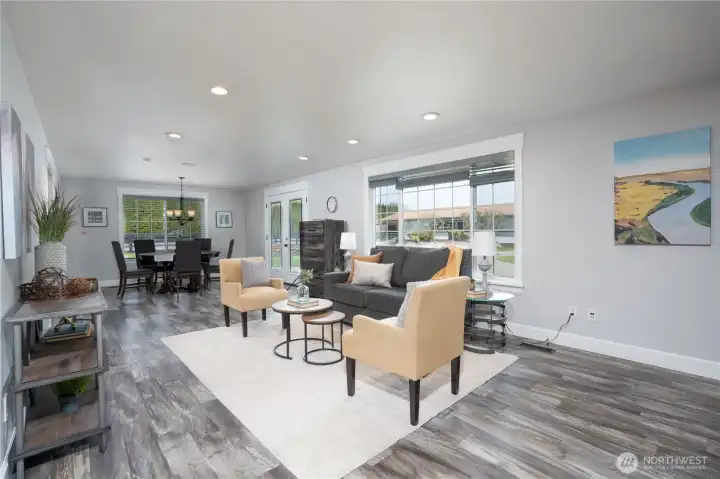Spacious living room and dinning room area - the large windows invite ample natural light in to the space, the French doors lead to back patio area.