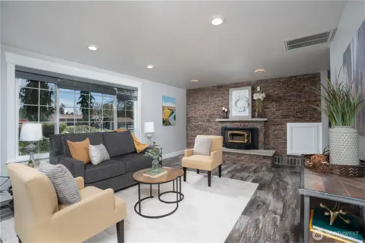 The cozy living room features a stone woodburning fireplace with insert to keep you nice and toasty warm!