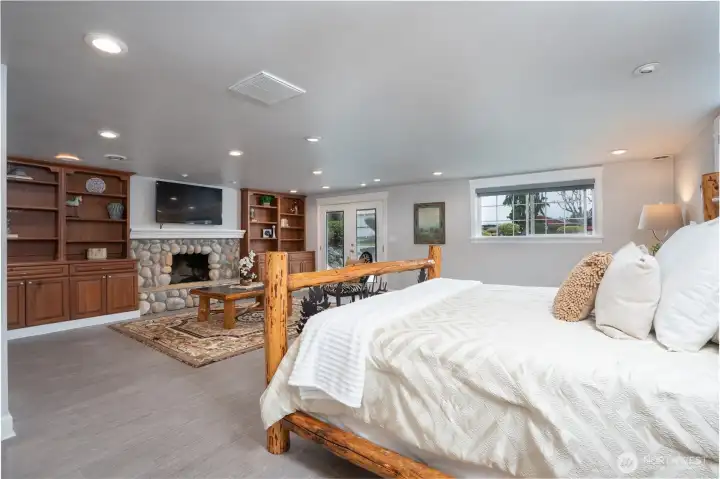 Spacious Primary en Suite complete with stone fire place & French doors that lead you the private patio with a relaxing hot tub - a great place to escape!