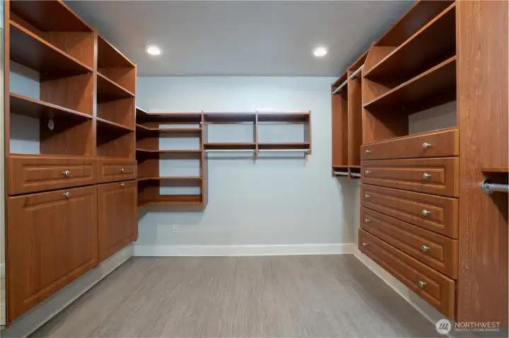 Larger walk-in closet in the Primary en Suite with a built-in closet system
