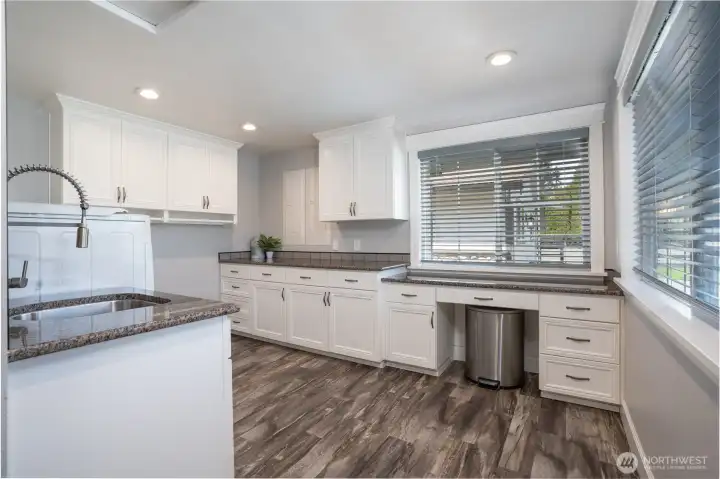 Now this is a laundry room! Loads of cabinets, utility sink, and tons of counter space perfect for folding laundry, washer & dryer both convey
