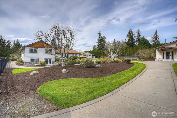 A view from the back of the stunning ground, the French doors on the home lead you to the Owner's retreat, the building on the right is the fully permitted Art studio which is fully conditioned & finished space.