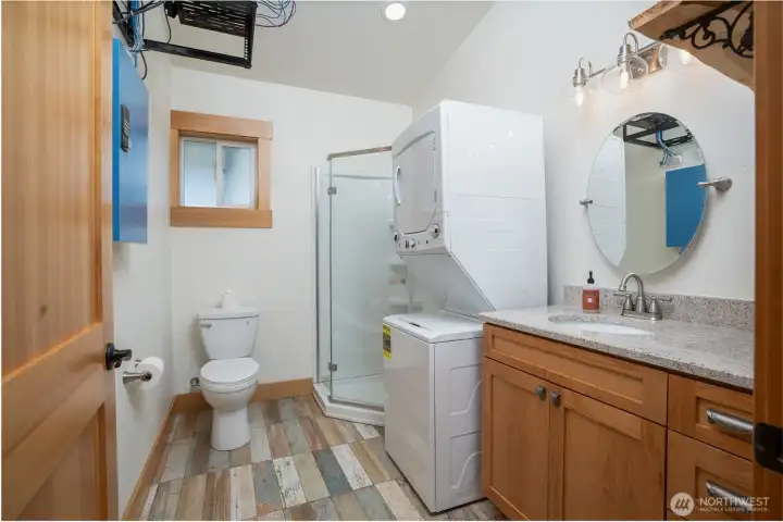 3/4 bathroom complete with on-demand water heater, vanity with quartz top and washer & dryer that convey.
