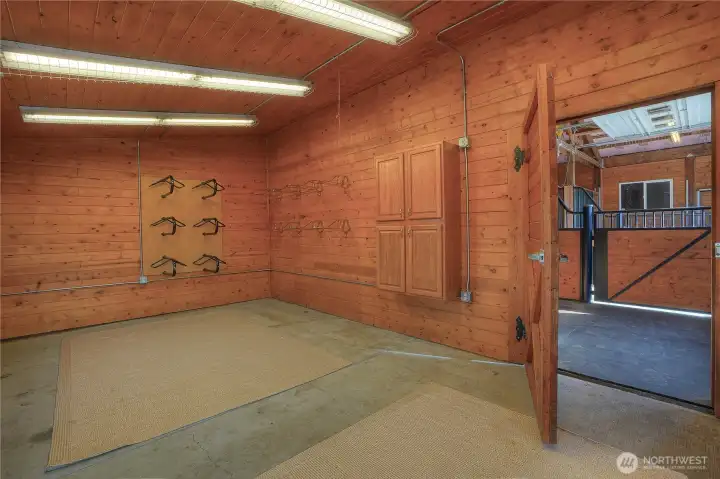Tack room with T&G walls and ceilings, easy access into the stall area. There is plenty of room to host all of your tack and togs in this generous space.