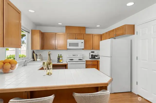 Cheerful kitchen with good counterspace. The large window allows for lots of sunlight. The refrigerator, dishwasher and garbage disposal were recently installed - (Virtual Staging)