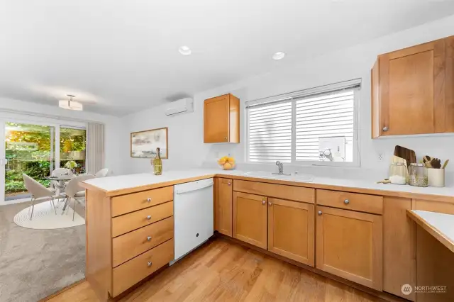 Functional kitchen with lots of cabinet and drawer space. Pleasant outlook to the rear yard.  (Virtual Staging)