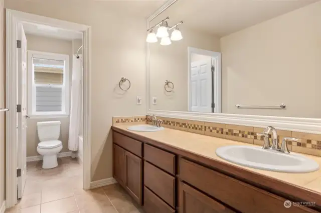 Upstairs full bathroom with dual sinks