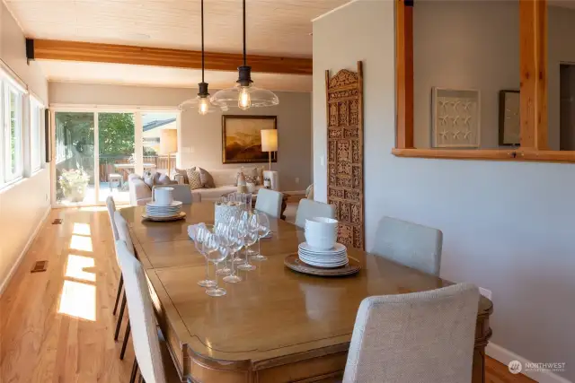 A wall of windows with voice controlled blinds bring the light into the dining area.