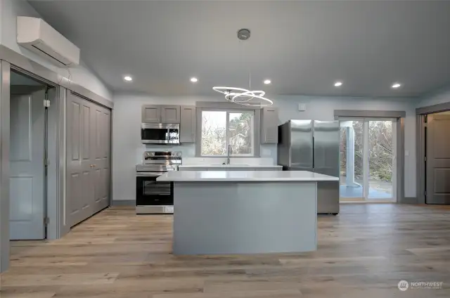 Kitchen features stainless steel appliances, and laundry closet.