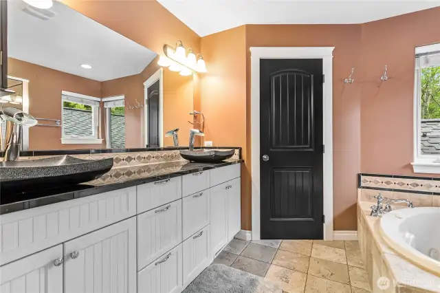 Dual sinks and a door on the commode for extra privacy.