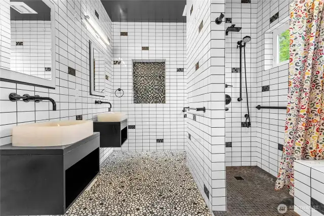 Custom en suite bathroom with dual sinks and a Roman shower. You've gotta see this!
