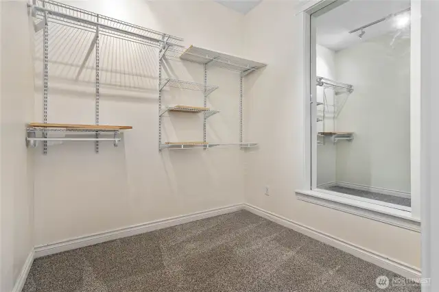 Walk-in closet is more like an additional room. There are water lines stubbed into the wall on the right. You could put a washer/dryer in here.