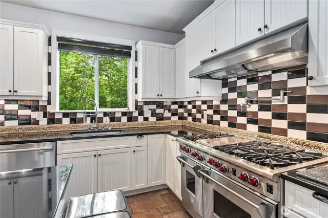 The kitchen is a chef's dream, complete with Wolf 6-burner range, grill, and double-oven. Also has a built-in pot filler.