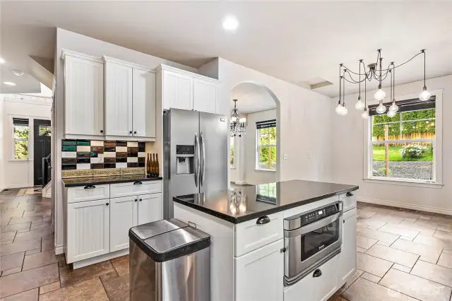 Looking across the kitchen back toward entry and the kitchen dining area.
