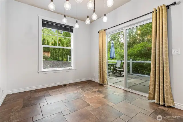 Plenty of space for a 4-6 person dining area. Step out the sliding doors to the private patio and new deck. You can hear the creek in the protected wetland behind the house.