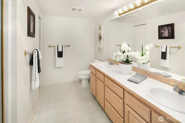 Primary bath with double sinks and roomy countertops and cabinetry!