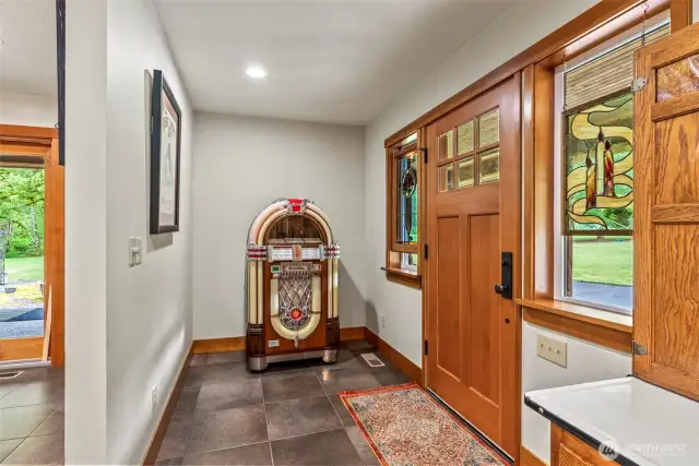 In the front entry, you can see as you walk in the craftsmanship that went into building this home.. Stunning Tile floors throughout the main level greet you. Beautiful finishes throughout the home.