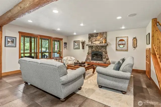 Open "Great Room" concept. With River Rock Fireplace ( Propane) for those cool winter evenings.. Cuddle up and and enjoy a book in this comfortable living room space.  ( check out the storage under the stairs too)