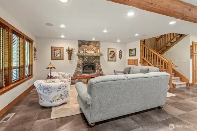 The log accents through out the main floor add a cozy feeling to the space. Log beams, Pillars and staircase give it the country charm with all the modern amenities.