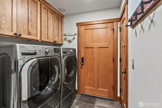Main floor laundry area leads to the 6 CAR GARAGE! There are 2 storage closets here and a 1/4 Bath too! Hickory cabinets in here as well!