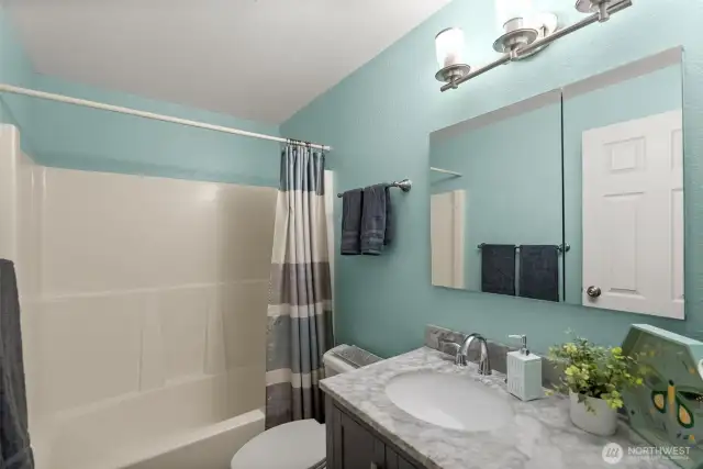 The upstairs bathroom has been completely remodeled, featuring modern finishes and a fresh, beautiful look.