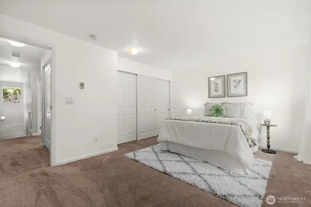 The second bedroom upstairs offers plenty of space and a huge closet, perfect for guests or a home office.