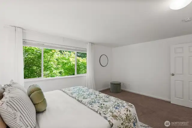 The upstairs bedroom includes an air conditioner insert, keeping the space cool and comfortable during warm summer nights.