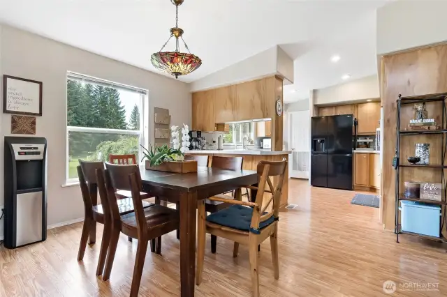 Dining area looking on to well laid out kitchen.